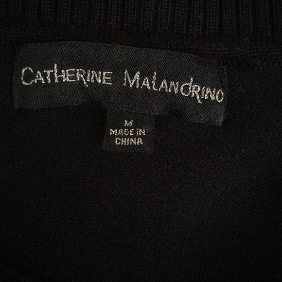 Black sweater with black and white striped sleeves. Great condition. - Picture 5 of 7